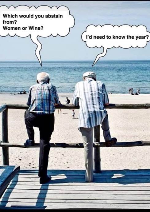 Two men leaning on a railing on a beach  Description automatically generated