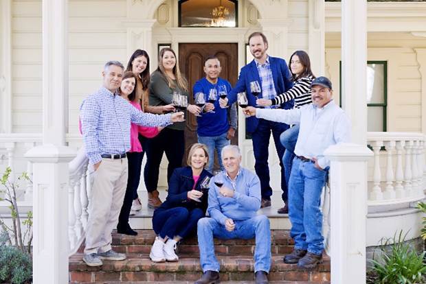 A group of people holding wine glasses  Description automatically generated