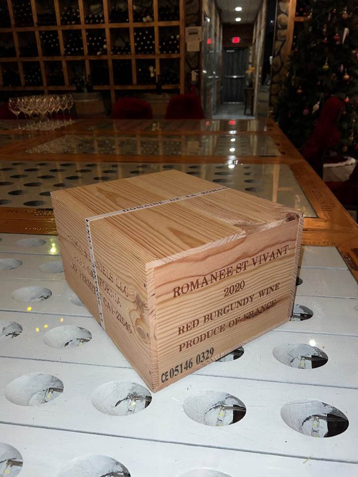 A wooden box on a white surface  Description automatically generated