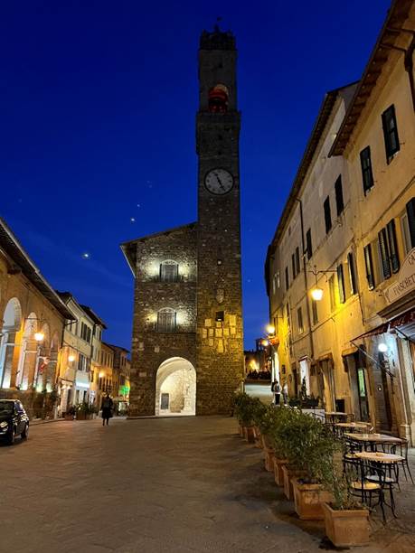 A stone tower with a clock on top  Description automatically generated