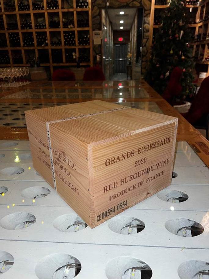 A wooden box on a table  Description automatically generated