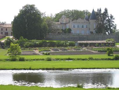 A large building with a pond in the background  Description automatically generated with medium confidence