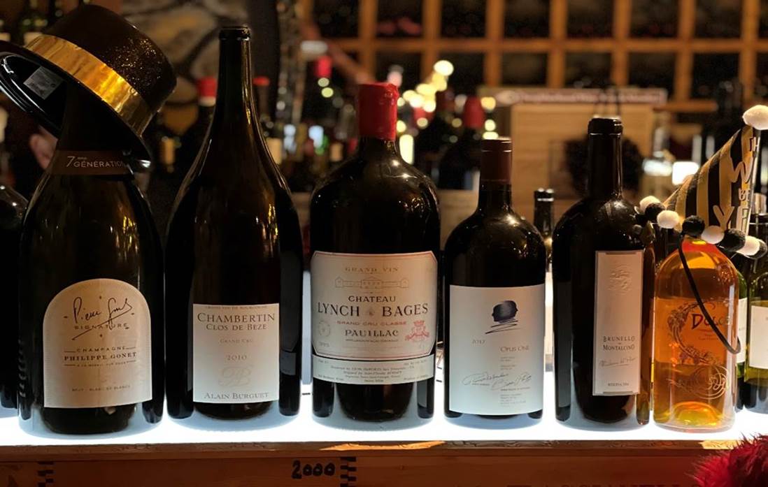 A group of bottles on a shelf  Description automatically generated with medium confidence