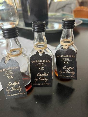 A group of small bottles with tags  Description automatically generated