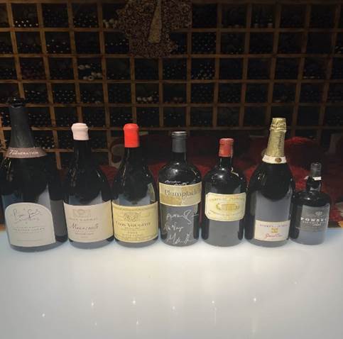 A row of wine bottles  Description automatically generated