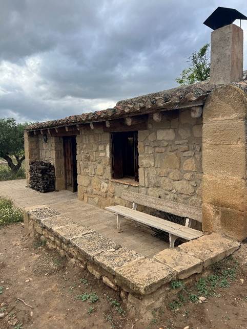 A stone building with a window  Description automatically generated