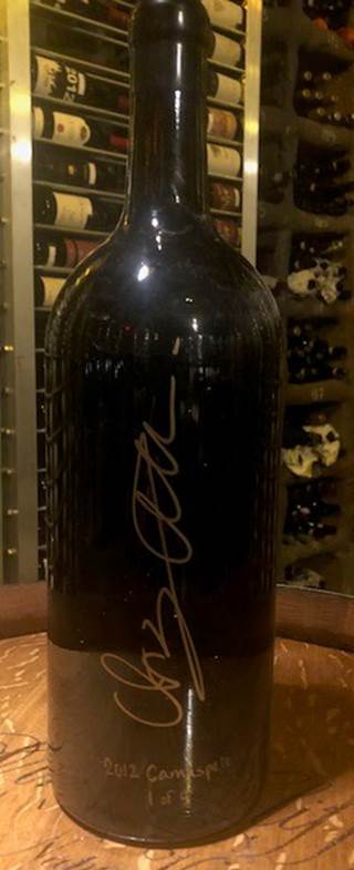 A black bottle with a white lid  Description automatically generated